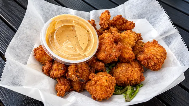 Crispy golden fried bites with a creamy dipping sauce
